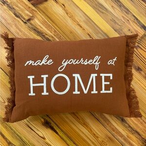 Brown/Rust Decorative Pillow with White Text